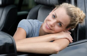 happy woman looking out of car window
